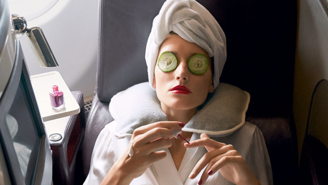 a woman with cucumbers on her eyes