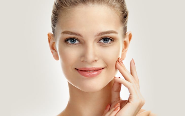 a woman touching her face