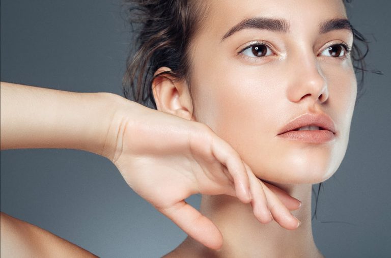 a woman with her hand on her face