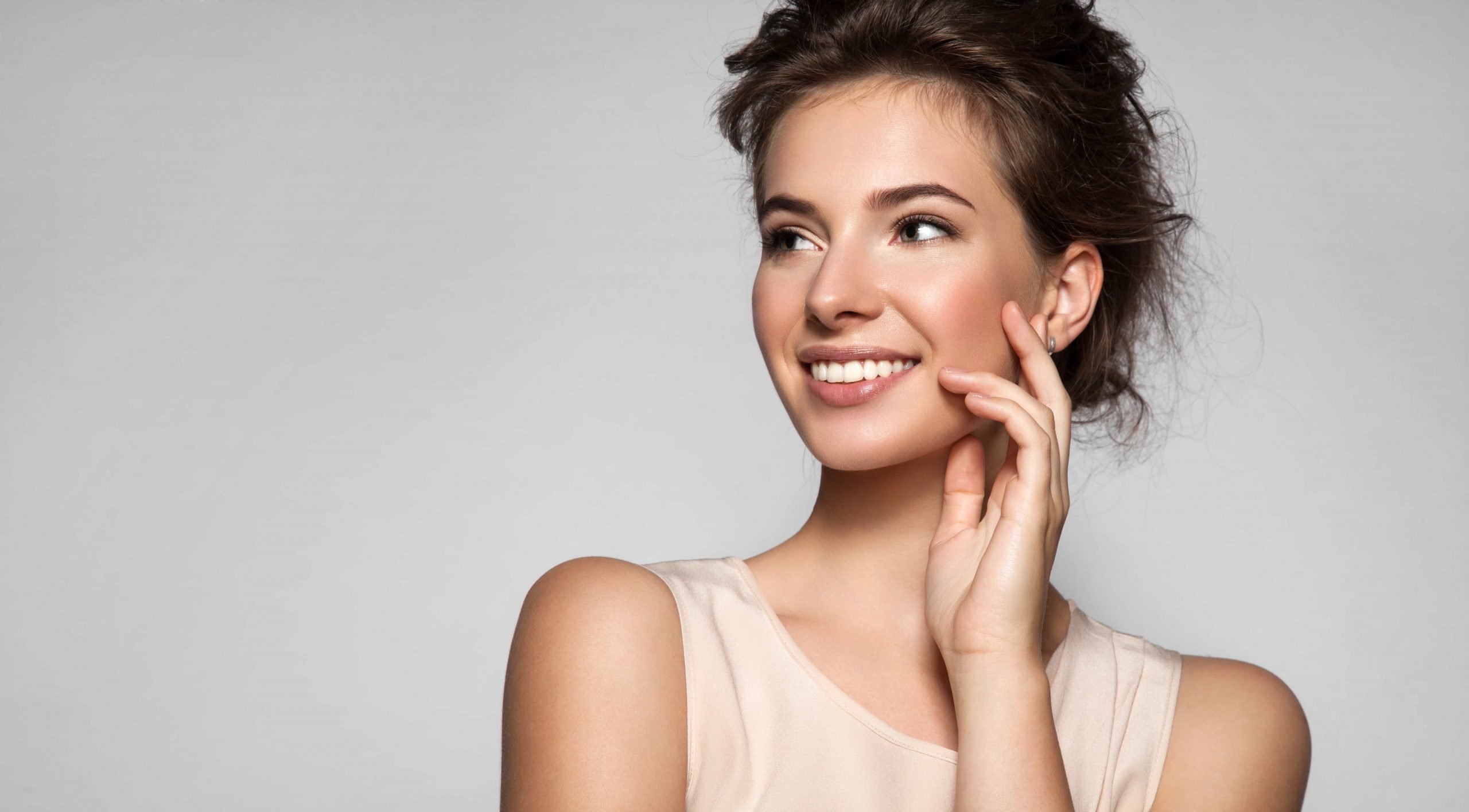 a woman with her hand on her face