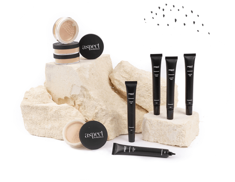 a group of makeup products on a rock