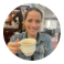 a woman holding a cup of coffee