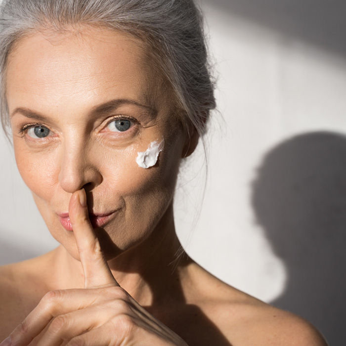 a woman with a finger on her nose