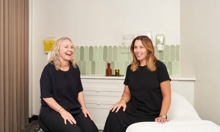 two women sitting on a couch